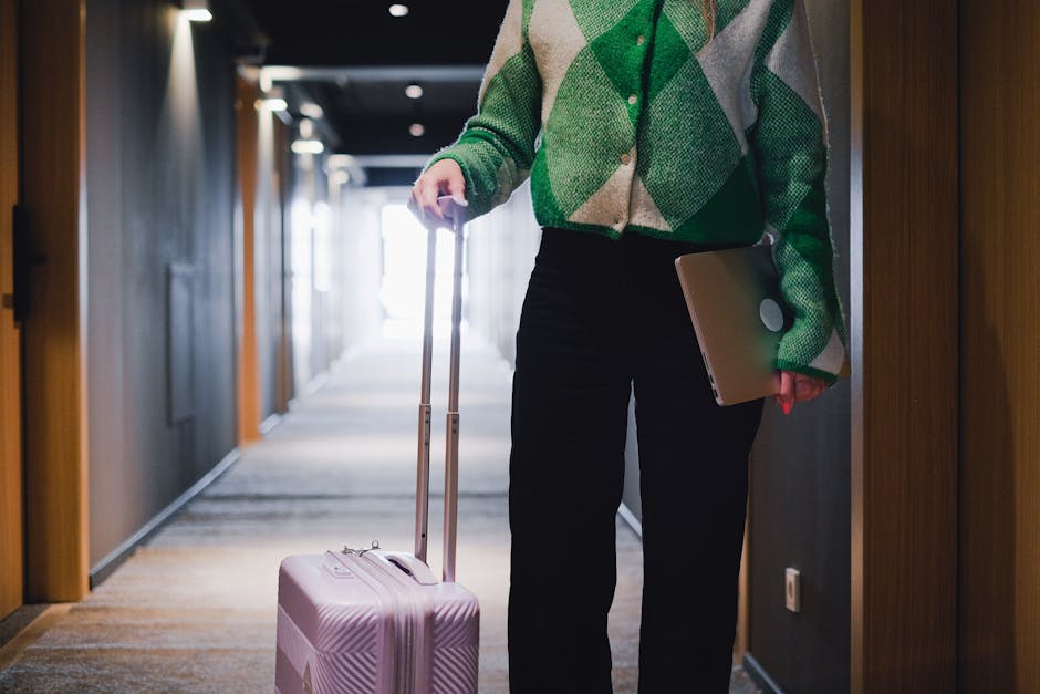 Business traveler reviewing a hotel booking on a laptop in an airport lounge